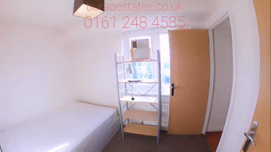Compact, tidy single bedroom with a bed, shelvi...