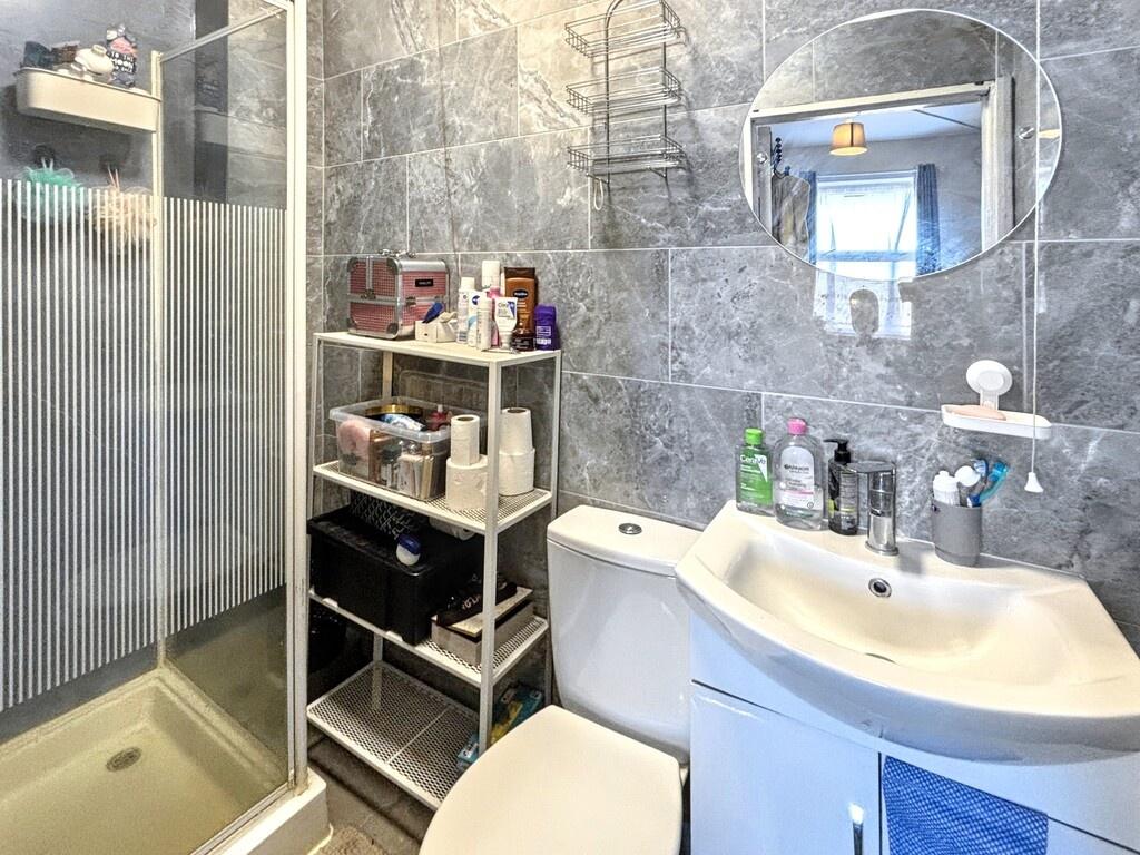 Modern tiled bathroom with a walk-in shower, wh...