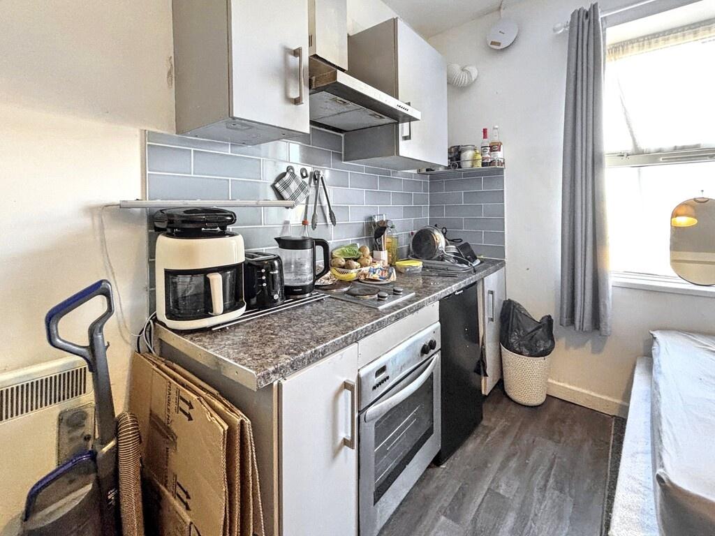 Compact, modern kitchenette with white cabinets...
