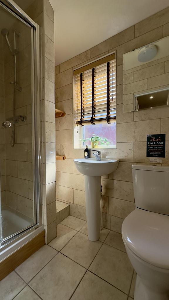 A clean and modern bathroom featuring a shower ...