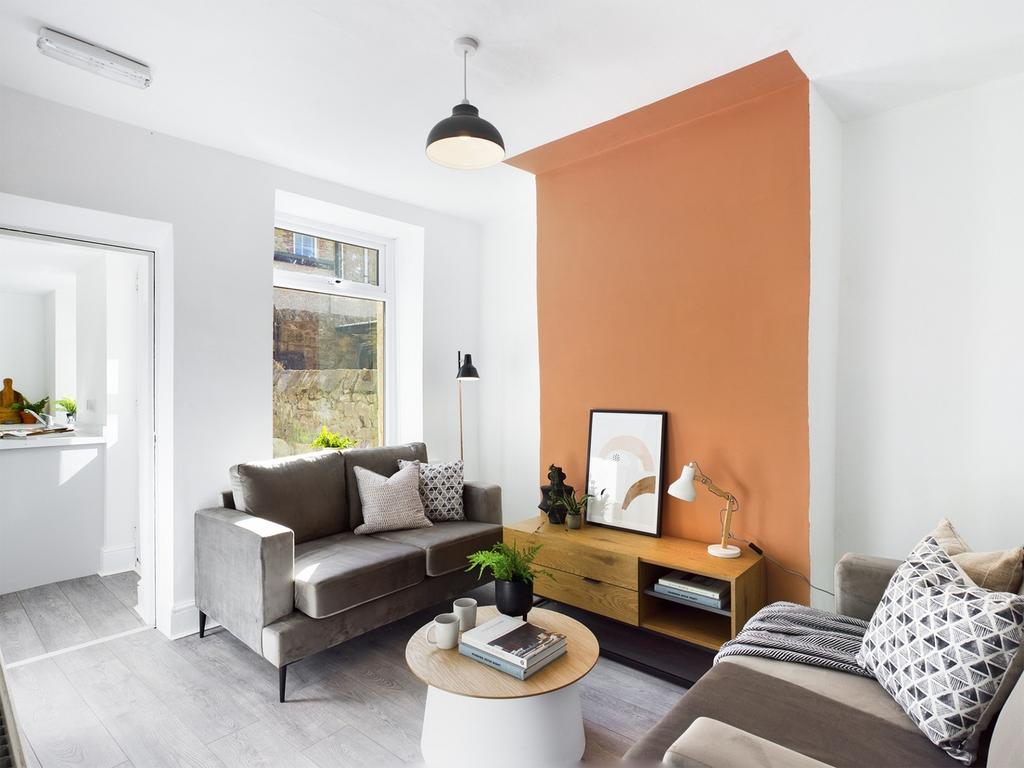 A stylish and spacious living room filled with ...