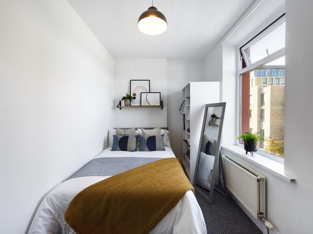 A bright and stylish double bedroom featuring m...
