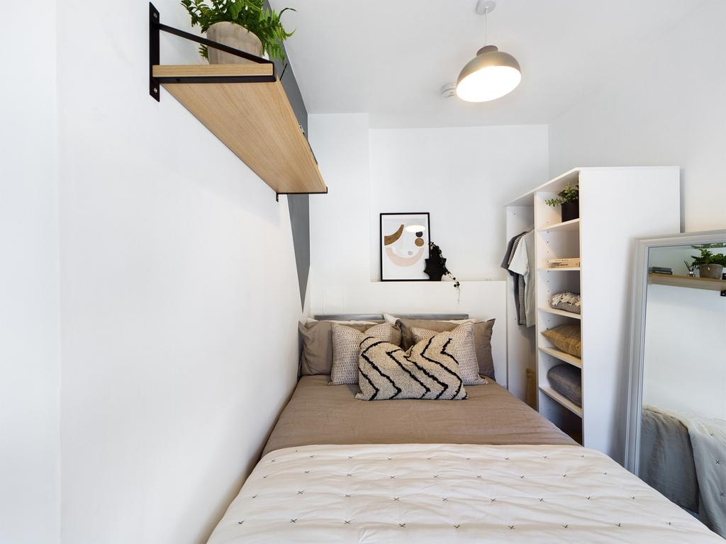 A bright and stylish double bedroom featuring m...
