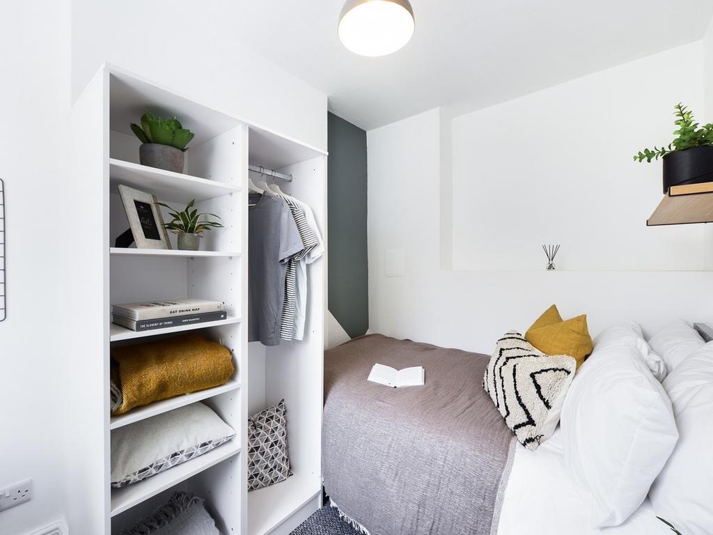 A cozy and well-lit double bedroom with stylish...