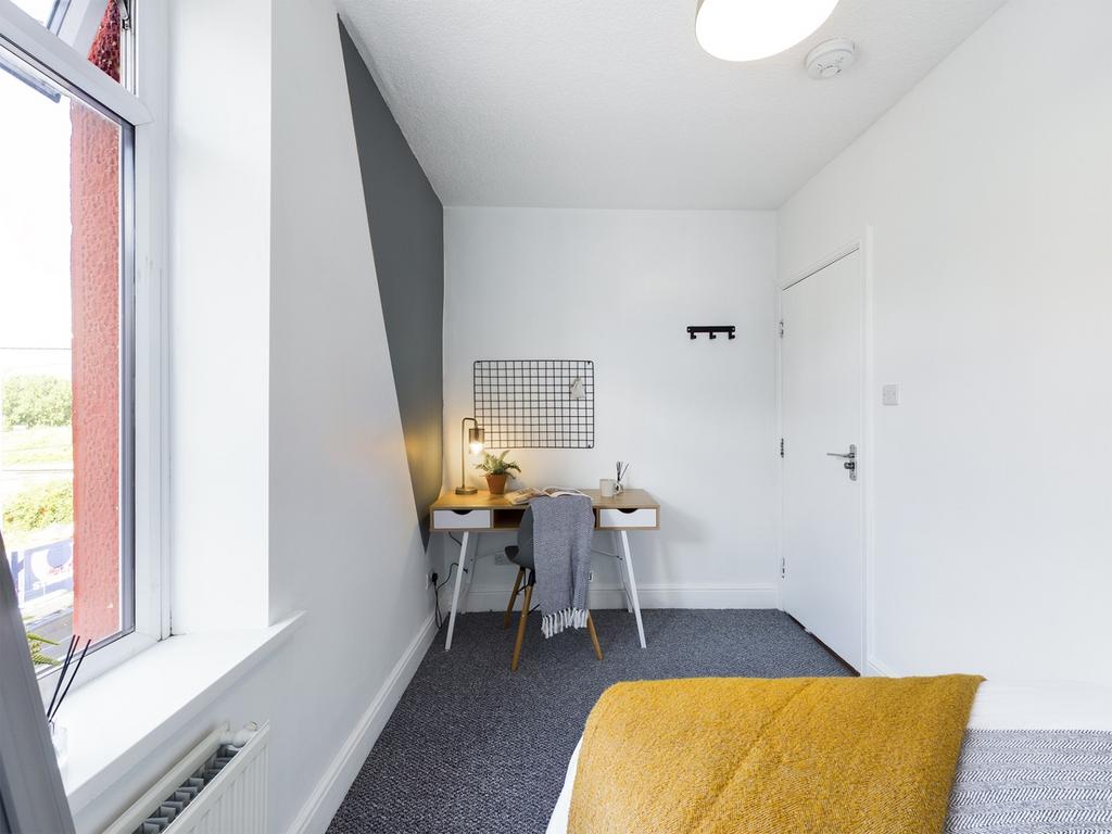 A bright and inviting double bedroom with a sty...