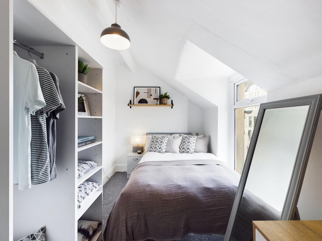 A bright and inviting double bedroom featuring ...