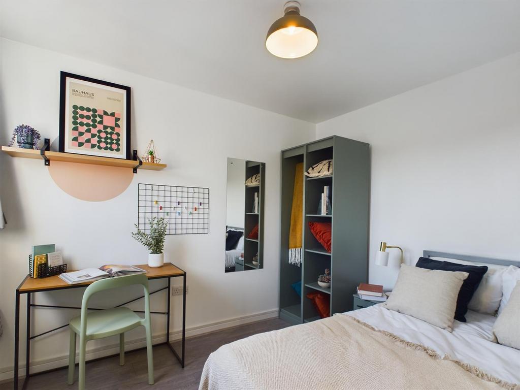 This inviting double bedroom features a stylish...