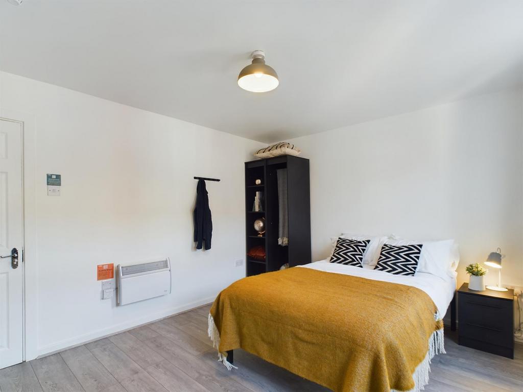 This inviting double bedroom features a cozy ae...