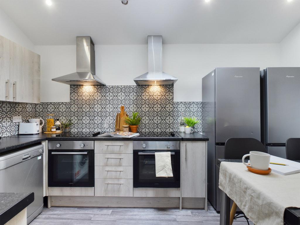 A modern and well-equipped kitchen featuring st...