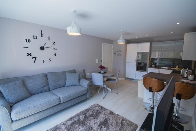 Bright, modern open-plan living area with a com...