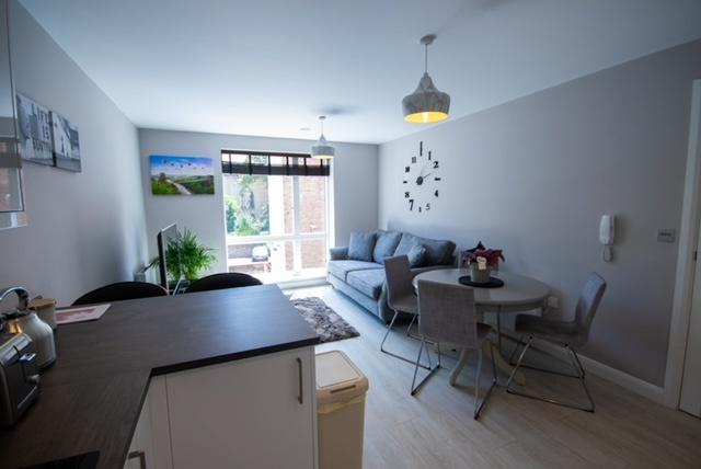 Bright, modern open-plan living area with a com...