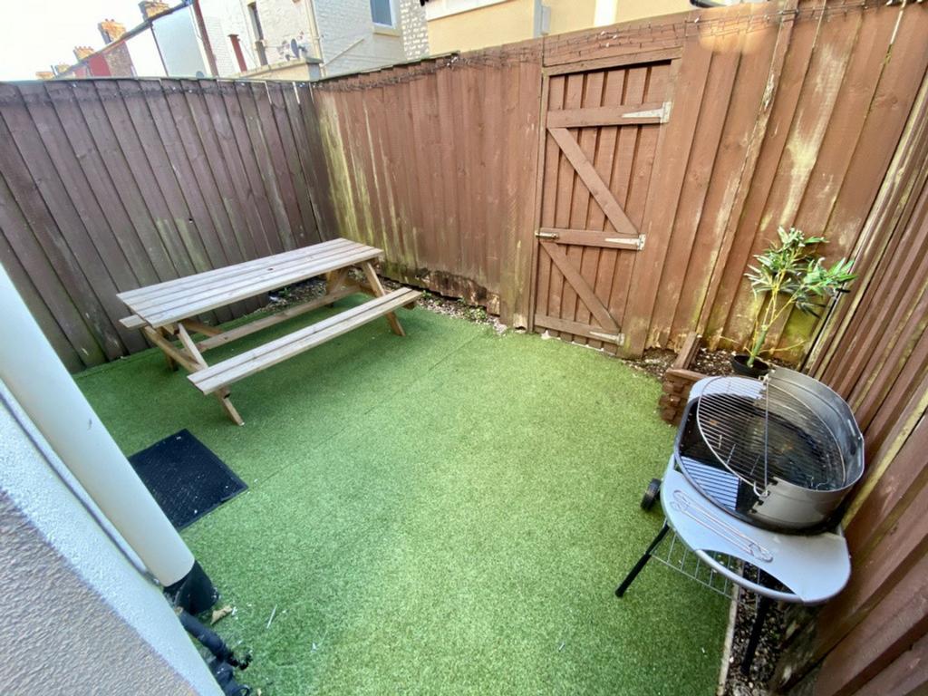 A charming garden space featuring a picnic tabl...