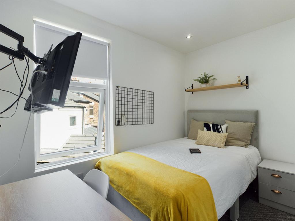 A bright and inviting double bedroom with moder...