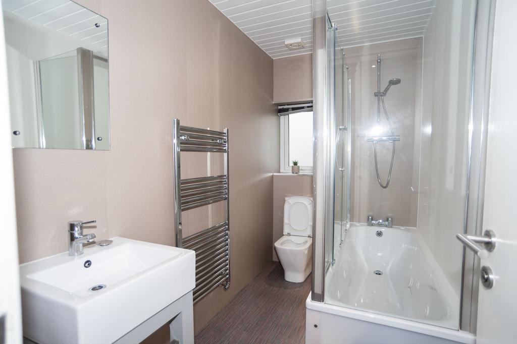 Bright, modern bathroom with a sleek white sink...