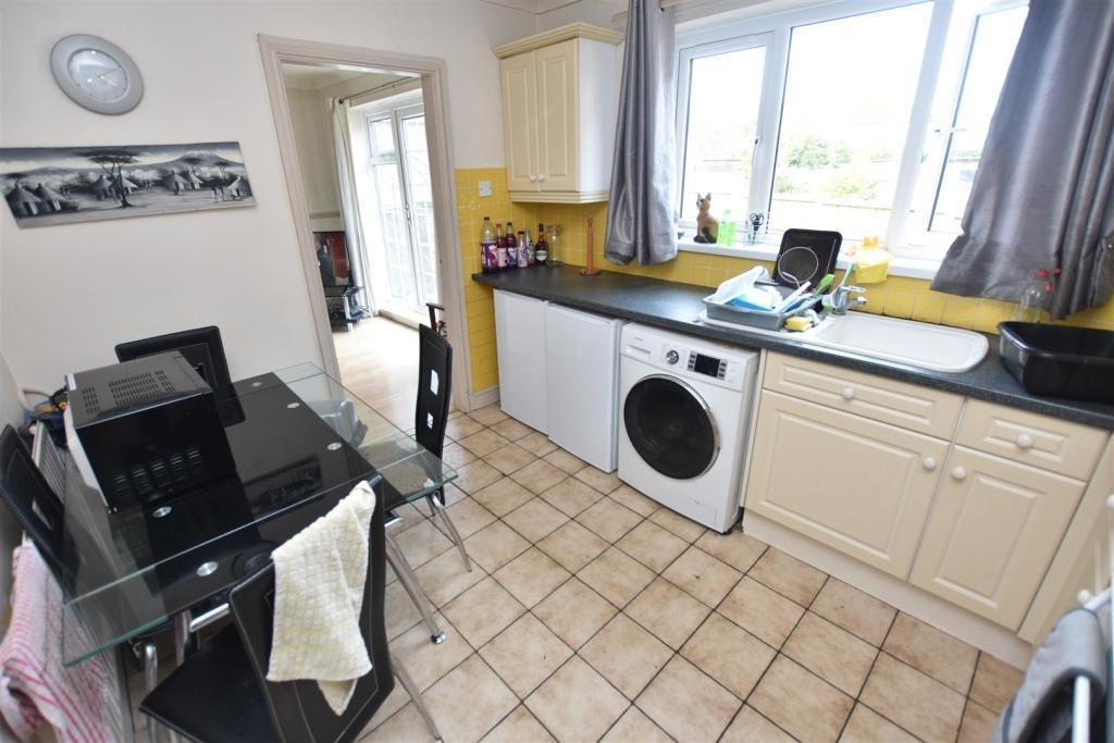 Bright, well-equipped kitchen with a large wind...