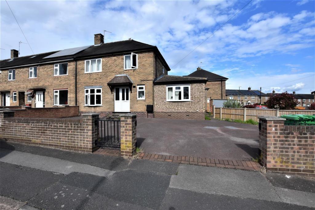 Brick semi-detached house with a wide paved dri...
