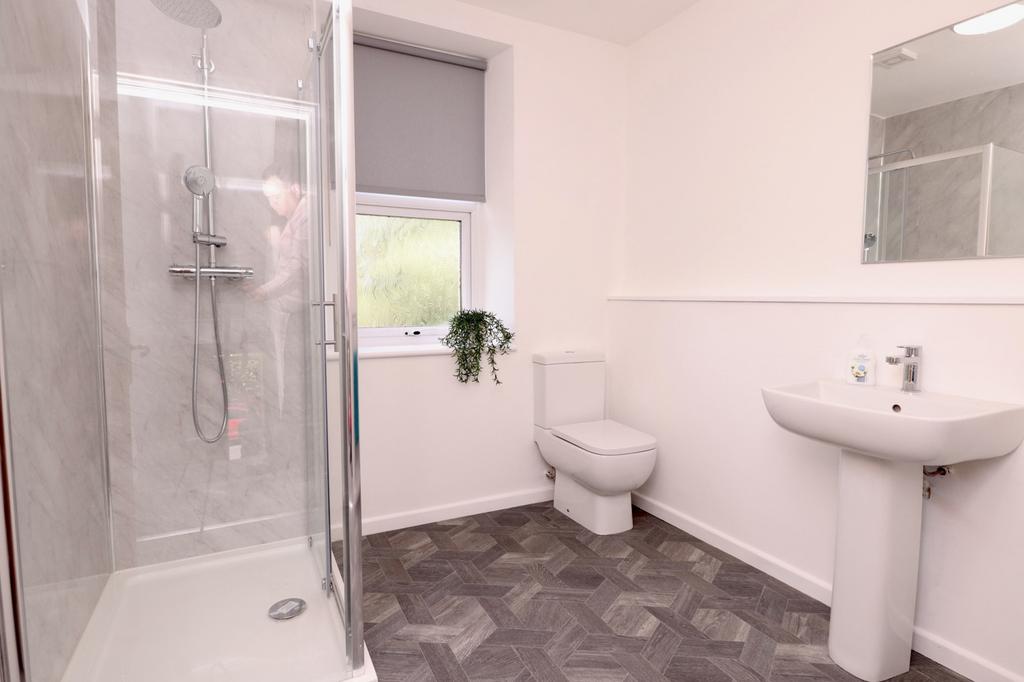 A modern and clean bathroom featuring a spaciou...