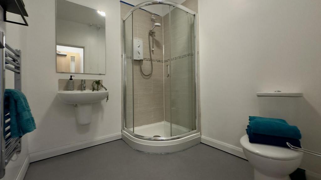 A modern and tidy bathroom featuring a spacious...