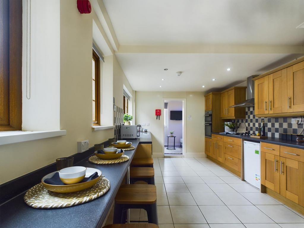 A spacious and modern kitchen with ample natura...
