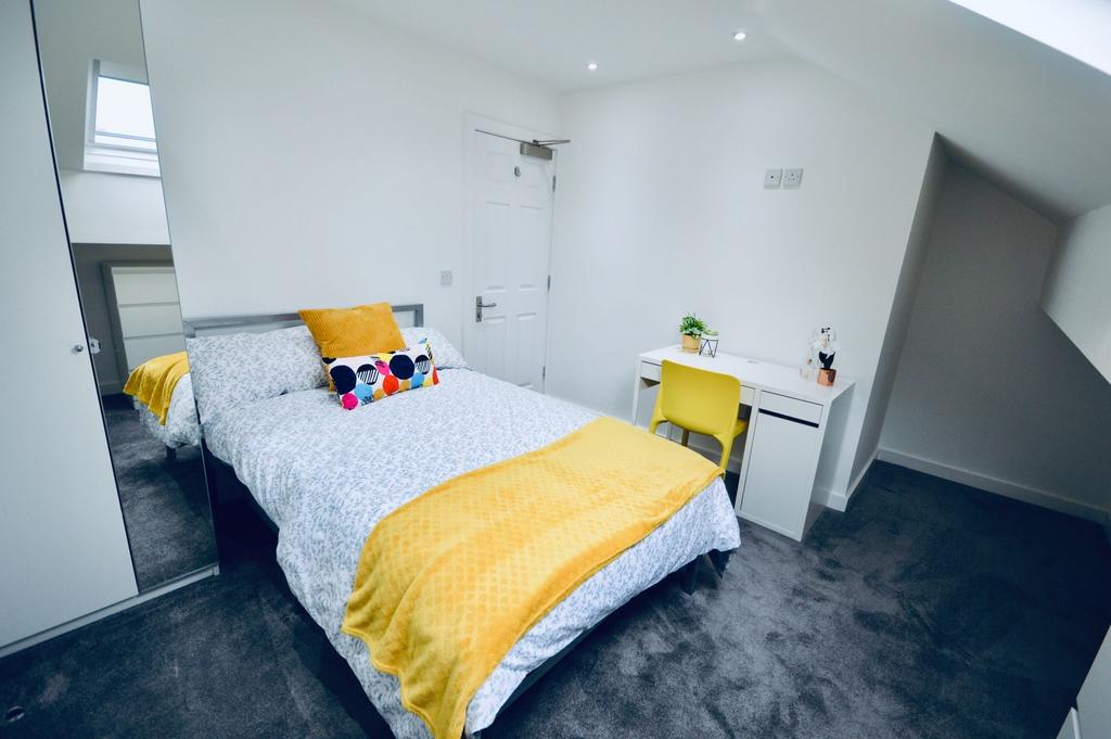 Bright and modern double bedroom featuring a la...