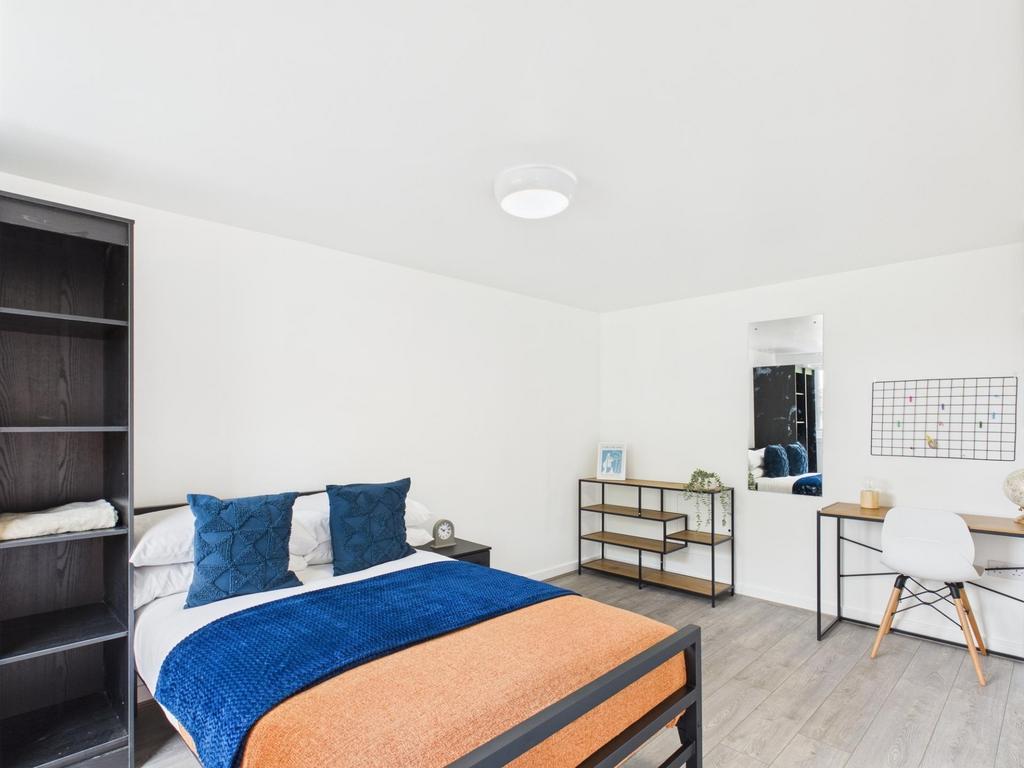 Bright, modern double bedroom with a comfortabl...