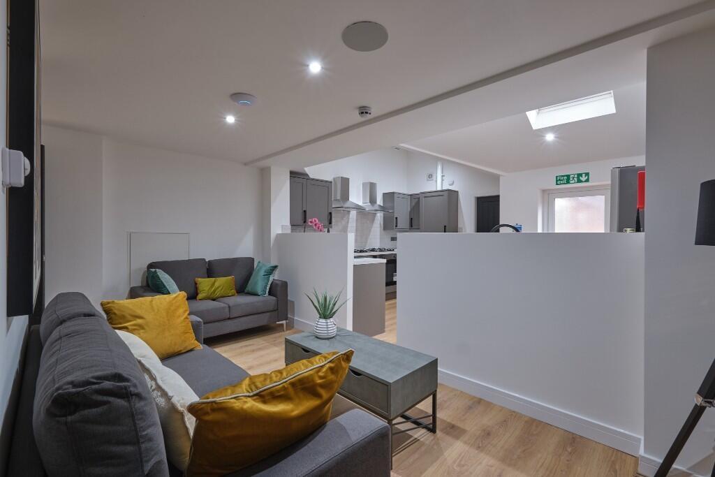 A modern and well-lit living room featuring a c...