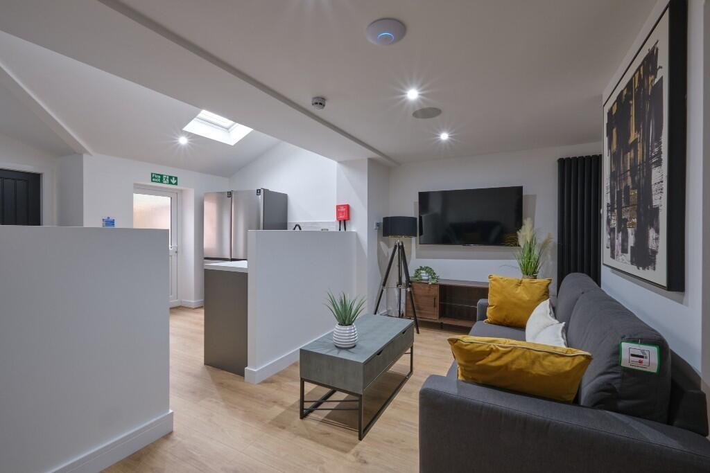 A modern, well-lit living room featuring comfor...