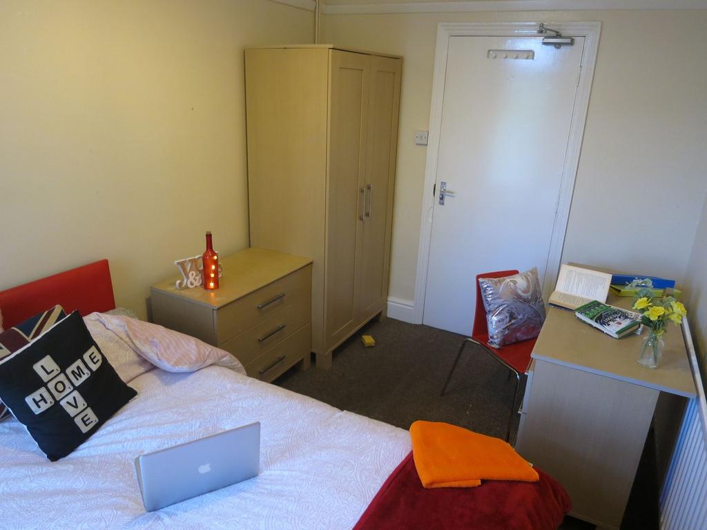 Neat single bedroom with a comfortable bed, bed...