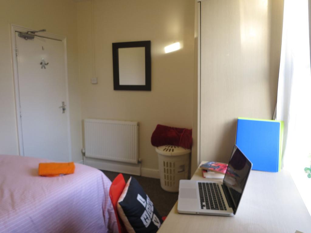 Bright single bedroom with a study desk by the ...