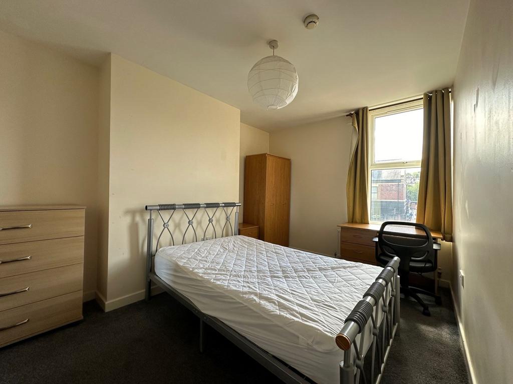Bright, neutrally decorated double bedroom with...
