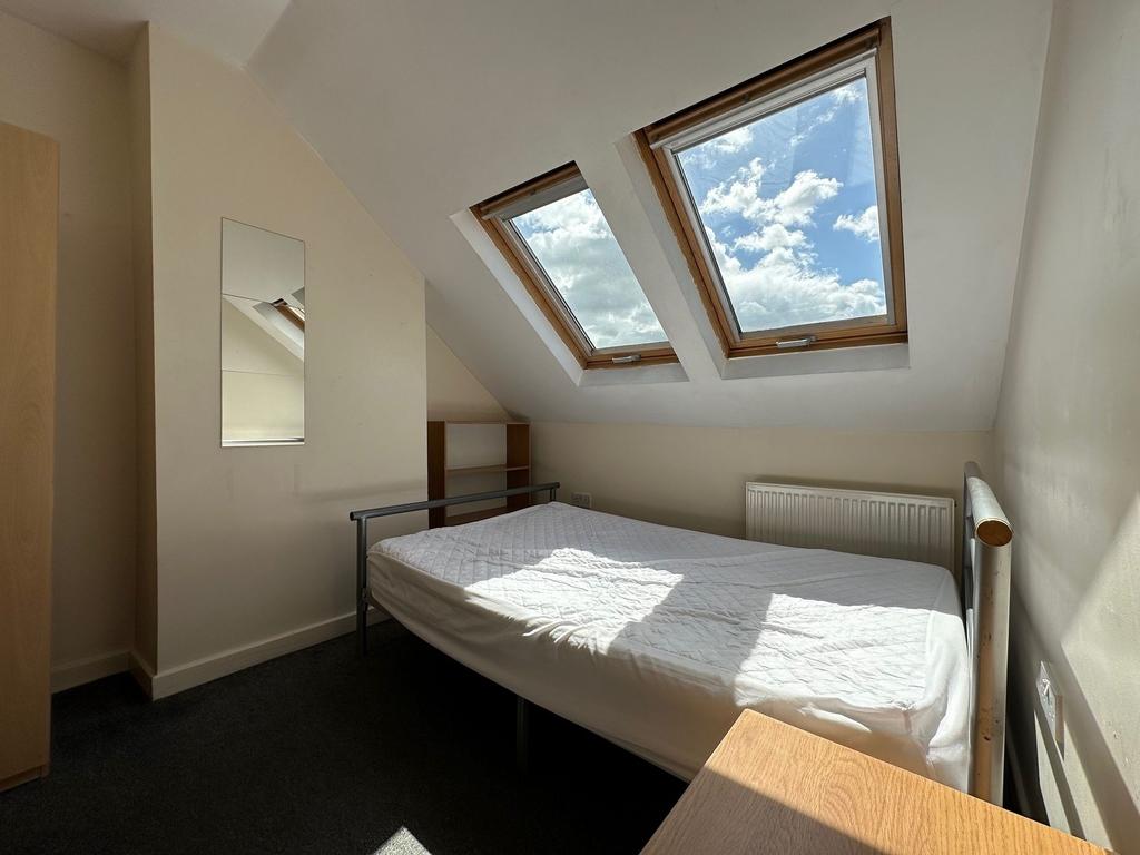 Bright attic double bedroom with two skylight w...