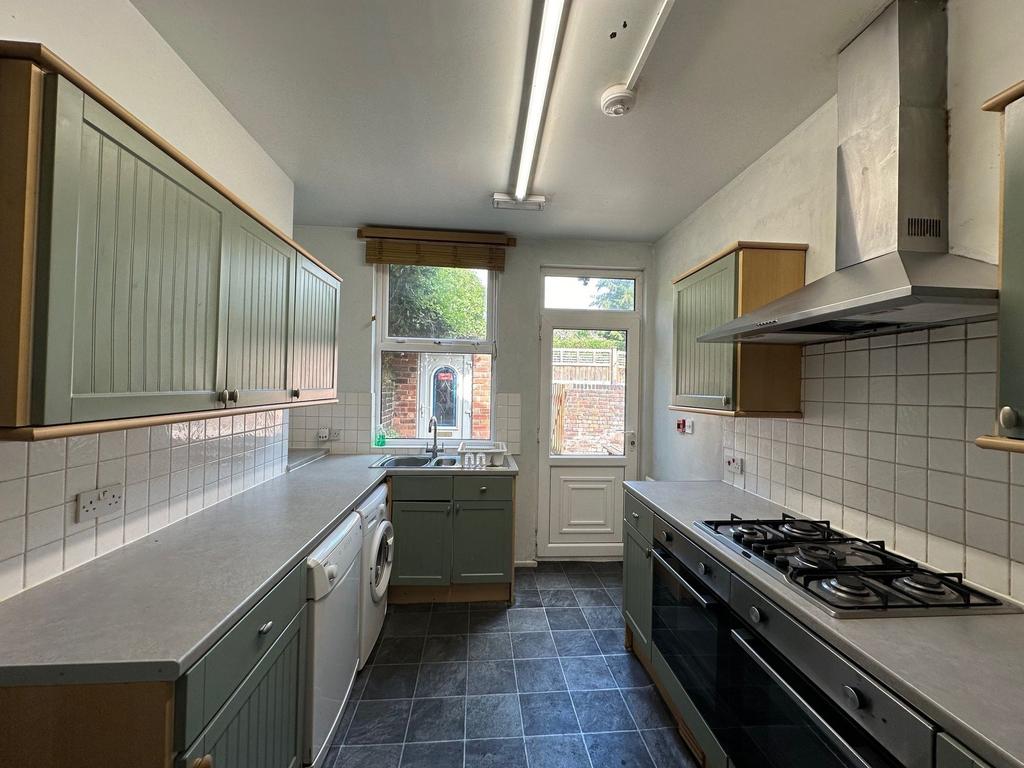 Bright galley kitchen with plenty of storage, f...