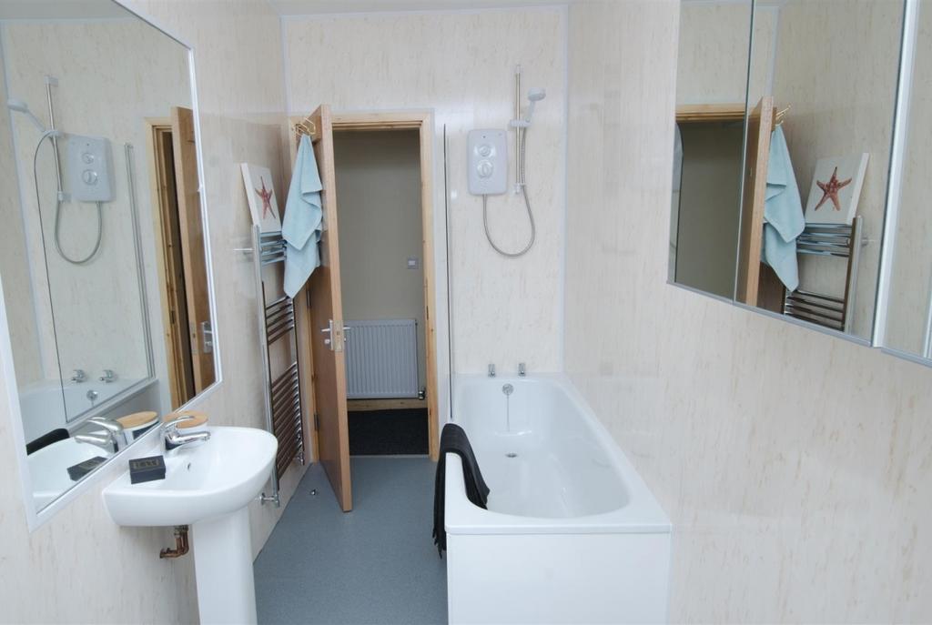 Bright, modern bathroom with a full-length bath...