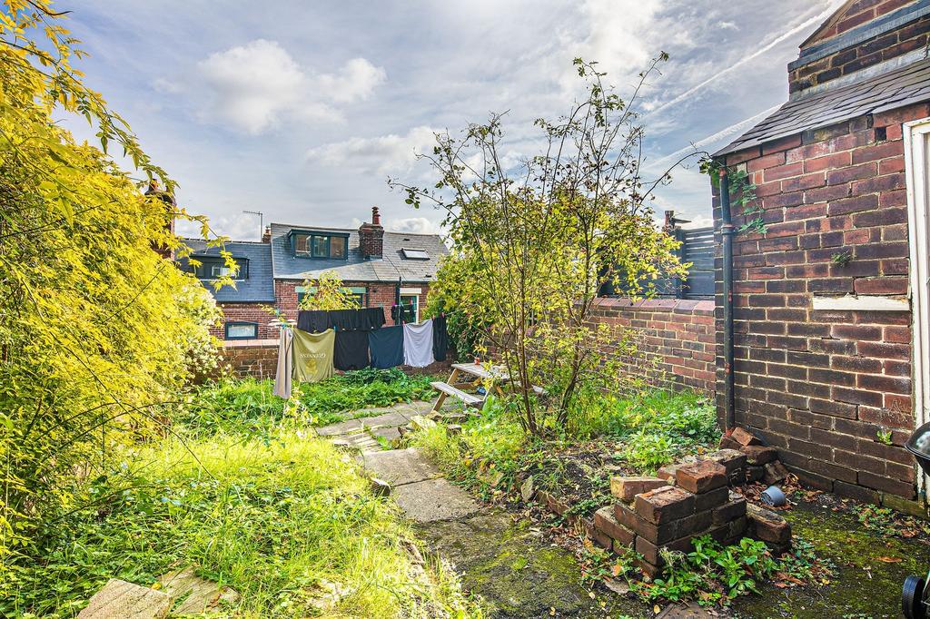 Sunny private rear garden with paved path, matu...