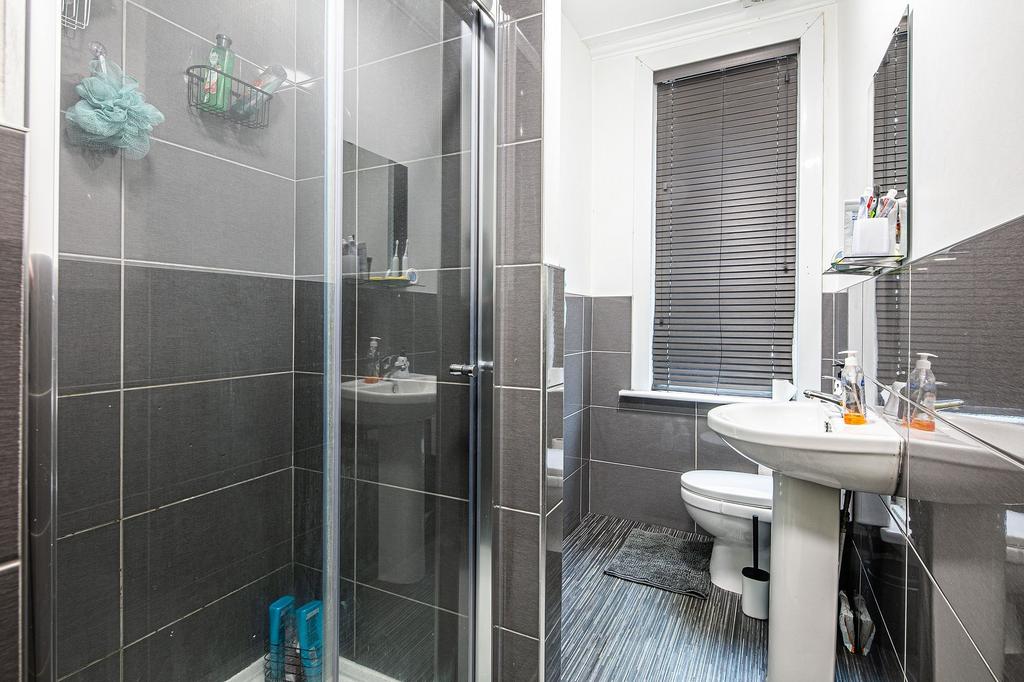 Modern bathroom with walk-in shower, pedestal s...
