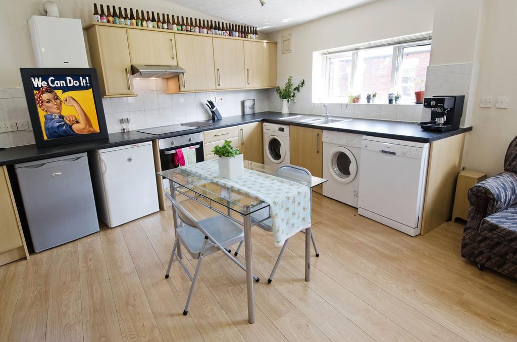 Bright, modern kitchen with light wood cabinets...