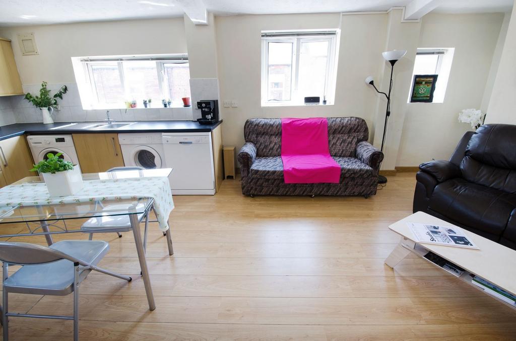 Bright open-plan living area with wooden floors...