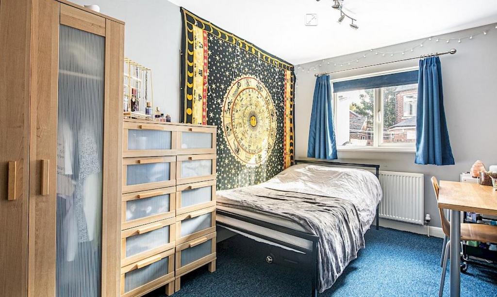 Bright, welcoming bedroom with a comfortable do...
