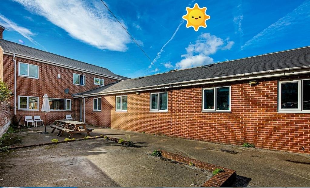 Sunny brick courtyard with outdoor seating and ...