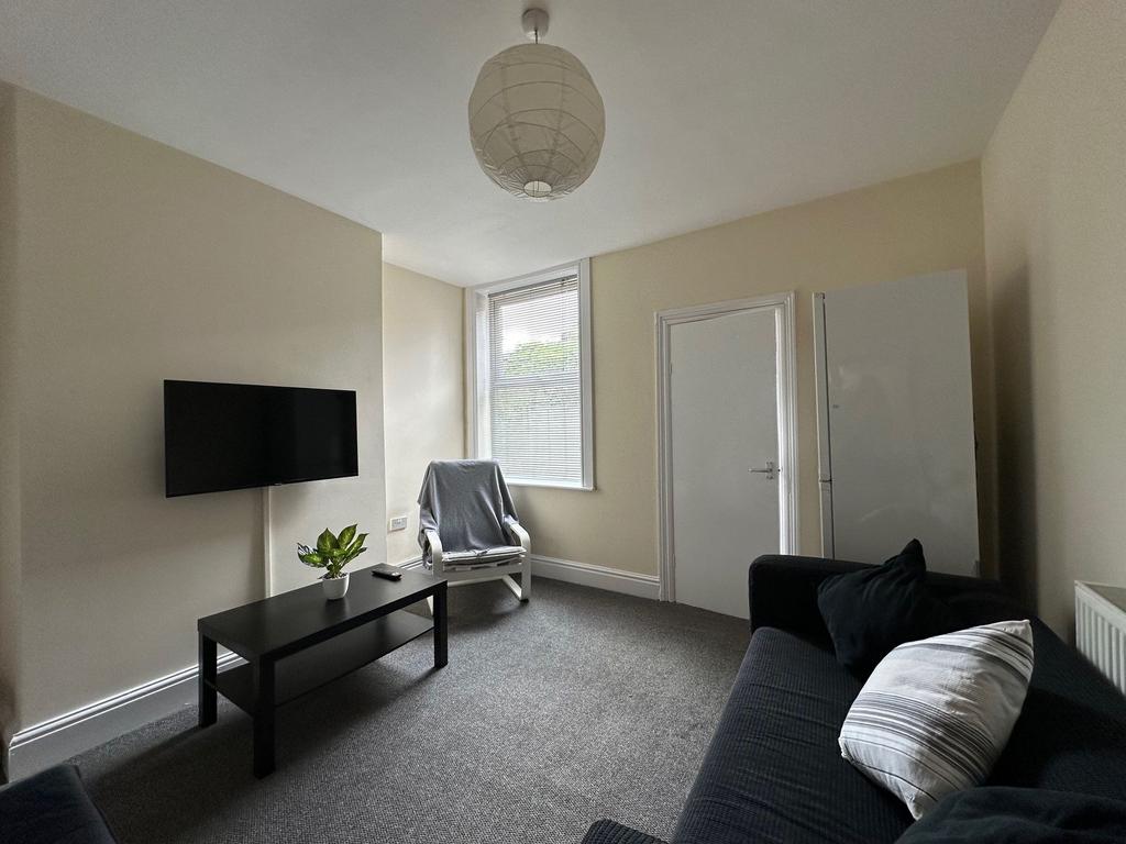 Well-presented living room with a wall-mounted ...