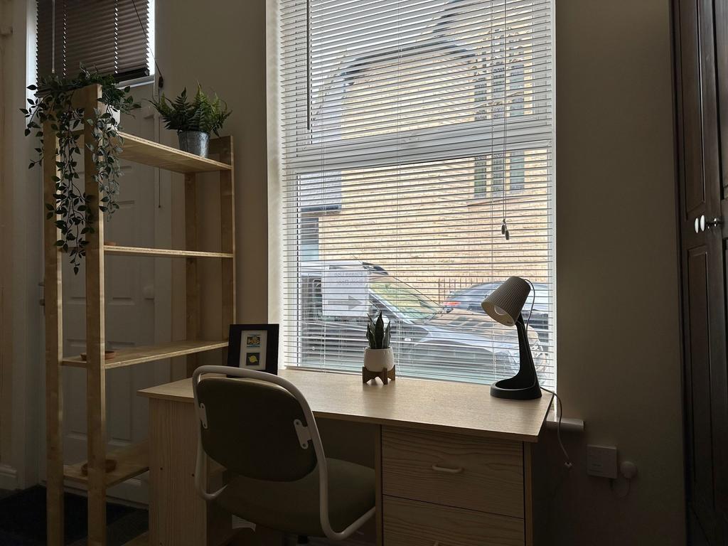 Bright ground-floor workspace with a large wind...