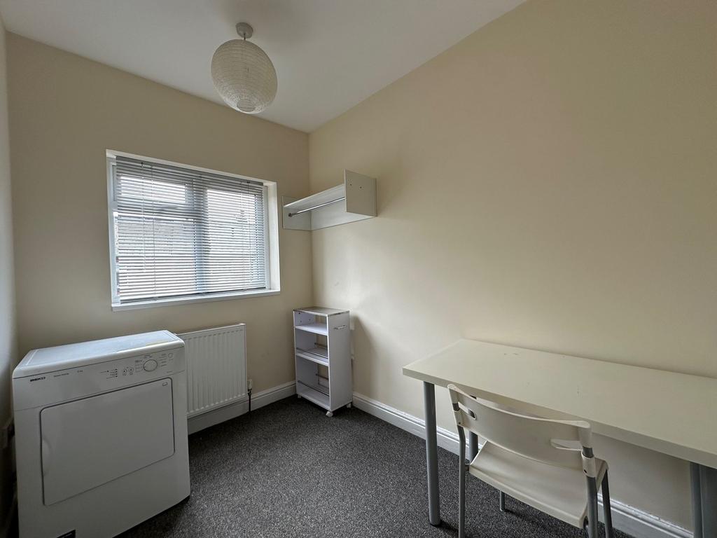 Bright, simply furnished single bedroom with a ...