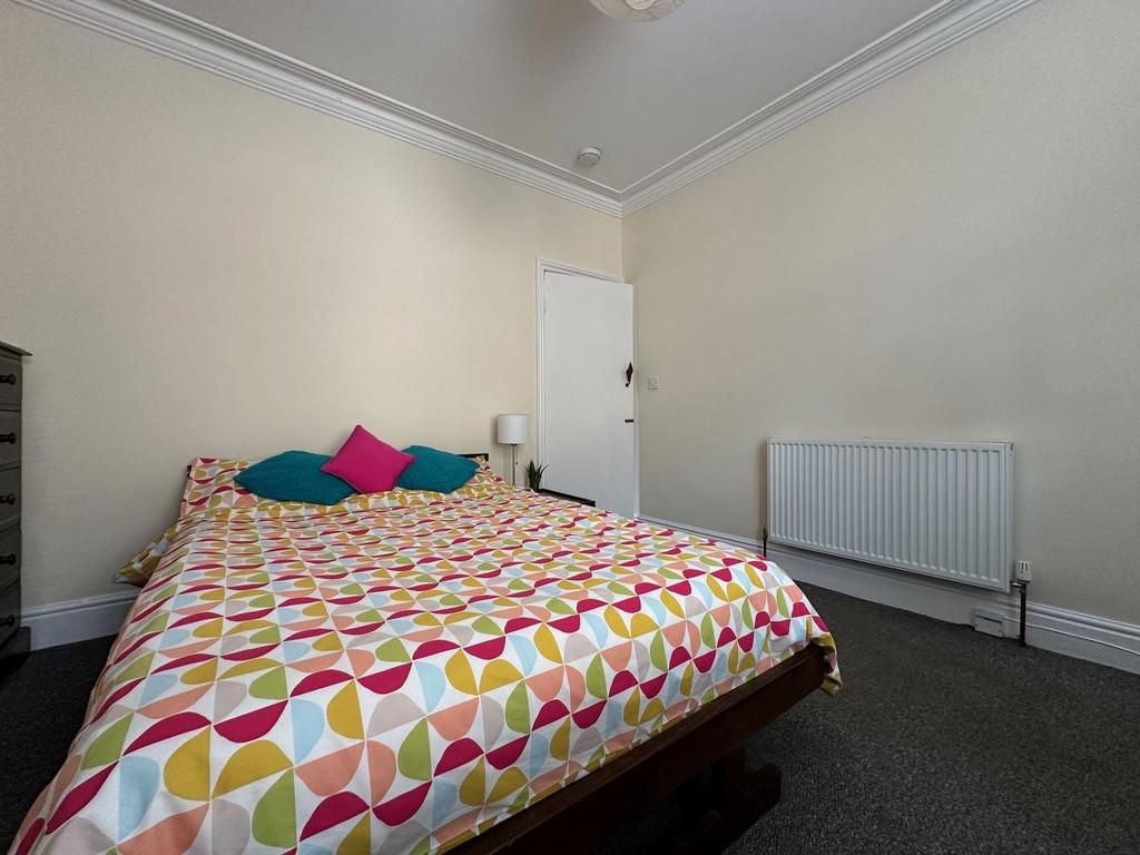 Bright, tidy double bedroom with patterned bedd...