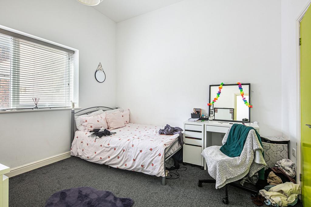 Bright, simply furnished double bedroom with a ...