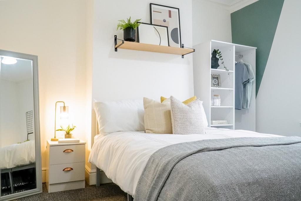 A beautifully styled double bedroom featuring a...