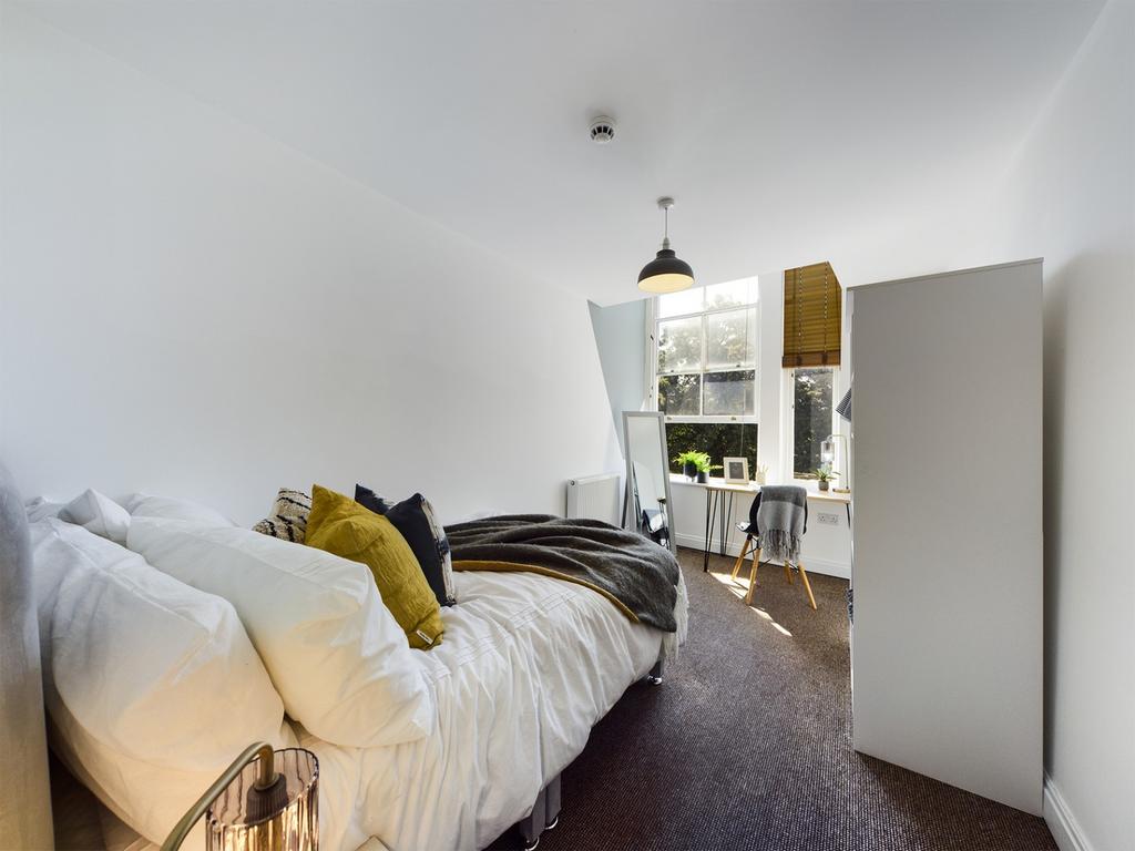 A bright and inviting double bedroom with moder...