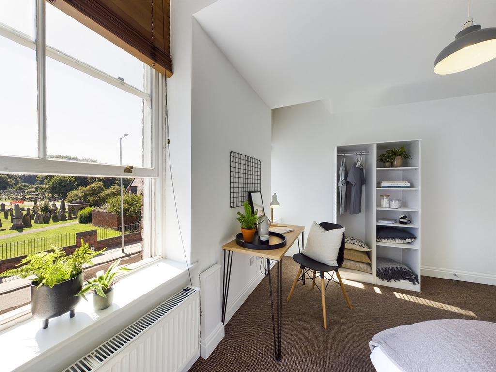 A bright and inviting double bedroom with ample...