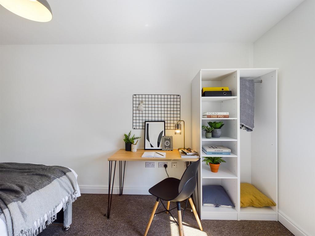 A bright and tidy double bedroom featuring a co...