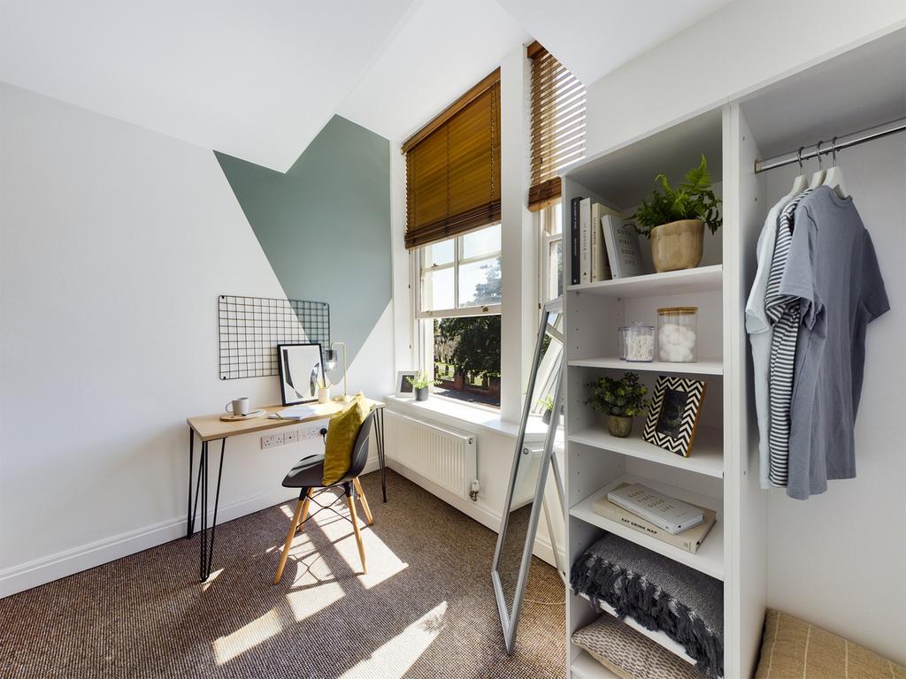 A bright and stylish double bedroom with a cozy...