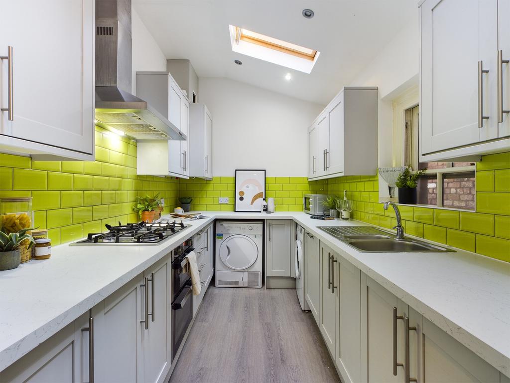 A bright and modern kitchen with vibrant green ...